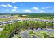 Community aerial view featuring a pond and homes, showcasing a harmonious blend of nature and neighborhood at 13536 Autumn Harvest Ave, Winter Garden, FL 34787