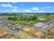 An overhead shot shows new construction homes in a developing community, featuring ponds and green spaces at 13536 Autumn Harvest Ave, Winter Garden, FL 34787