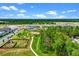 A lush landscape with homes, community pool and play area by a picturesque lake at 13536 Autumn Harvest Ave, Winter Garden, FL 34787
