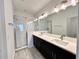 Bathroom features a double sink vanity, walk-in shower with glass door, and modern fixtures at 13536 Autumn Harvest Ave, Winter Garden, FL 34787