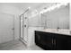 Bathroom features double sink vanity with modern lighting and glass enclosed shower at 13536 Autumn Harvest Ave, Winter Garden, FL 34787