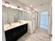 Modern bathroom featuring double sinks, sleek cabinetry, and a frameless glass shower at 13536 Autumn Harvest Ave, Winter Garden, FL 34787