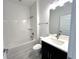 Well-lit bathroom with a tub-shower combo, modern vanity, and tile flooring at 13536 Autumn Harvest Ave, Winter Garden, FL 34787
