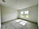 Spacious bedroom bathed in sunlight with two windows offering views at 13536 Autumn Harvest Ave, Winter Garden, FL 34787
