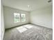 Bright, carpeted bedroom featuring windows and ample natural light at 13536 Autumn Harvest Ave, Winter Garden, FL 34787