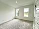 Bright bedroom featuring large windows, neutral walls, and plush carpeting at 13536 Autumn Harvest Ave, Winter Garden, FL 34787