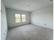 A serene, well-lit bedroom space with two large windows offering ample natural light and scenic views at 13536 Autumn Harvest Ave, Winter Garden, FL 34787