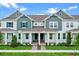 Charming two-story townhome with a covered porch and manicured landscaping at 13536 Autumn Harvest Ave, Winter Garden, FL 34787