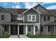 Gray two-story townhome boasts a welcoming covered entryway at 13536 Autumn Harvest Ave, Winter Garden, FL 34787
