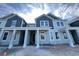 Charming, newly constructed two-story townhome with blue and light-blue siding and white trim details at 13536 Autumn Harvest Ave, Winter Garden, FL 34787