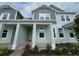 Charming home featuring a covered porch with columns and a beautifully landscaped yard at 13536 Autumn Harvest Ave, Winter Garden, FL 34787