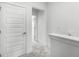 Bright hallway features gray carpet and white walls, doors, and trim at 13536 Autumn Harvest Ave, Winter Garden, FL 34787