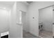 Bright hallway leads to a laundry room with modern washer and dryer at 13536 Autumn Harvest Ave, Winter Garden, FL 34787