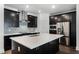 Modern kitchen features stainless appliances, dark cabinetry, and a central island with quartz countertop at 13536 Autumn Harvest Ave, Winter Garden, FL 34787