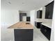 Bright kitchen with ample storage, dark cabinets, white countertops, and center island with prep area at 13536 Autumn Harvest Ave, Winter Garden, FL 34787
