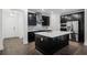 Spacious kitchen featuring dark cabinets, stainless appliances, and a central island with quartz countertop at 13536 Autumn Harvest Ave, Winter Garden, FL 34787
