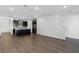 Open-concept living room connects to a kitchen with dark wood floors and recessed lighting at 13536 Autumn Harvest Ave, Winter Garden, FL 34787
