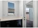 Mud room featuring a black cabinet with granite countertop, and a door to the brick paved porch at 13536 Autumn Harvest Ave, Winter Garden, FL 34787