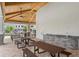 A picnic pavilion is shown with a brick barbecue with sink, picnic tables and attractive exposed-beam vaulted ceiling at 13536 Autumn Harvest Ave, Winter Garden, FL 34787