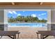 Community pool view from picnic area with pavilion and beautiful green landscaping at 13536 Autumn Harvest Ave, Winter Garden, FL 34787