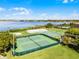 An aerial view of the tennis courts, basketball court, and hockey rink near a lake at 13722 Fox Glove St, Winter Garden, FL 34787