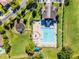 Aerial view of a community pool, playground, and lush green spaces at 13722 Fox Glove St, Winter Garden, FL 34787