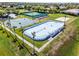 Aerial shot of the sports area showing the tennis court, basketball court, and hockey rink at 13722 Fox Glove St, Winter Garden, FL 34787