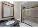 Bathroom featuring tiled shower with glass door and sleek vanity with dark wood and granite countertop at 13722 Fox Glove St, Winter Garden, FL 34787