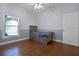 Charming bedroom featuring hardwood floors, a rustic bed frame, and bright natural light from the window at 13722 Fox Glove St, Winter Garden, FL 34787