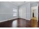 Empty bedroom with natural light, wood floors, and closet space at 13722 Fox Glove St, Winter Garden, FL 34787