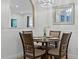 Cozy dining area with seating for four and a decorative chandelier at 13722 Fox Glove St, Winter Garden, FL 34787