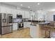 Open kitchen featuring stainless steel appliances, white cabinets, and a breakfast bar at 13722 Fox Glove St, Winter Garden, FL 34787