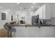 Bright open kitchen with stainless steel appliances, white cabinets, and breakfast bar at 13722 Fox Glove St, Winter Garden, FL 34787