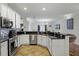Bright open kitchen with stainless steel appliances, white cabinets, and breakfast bar at 13722 Fox Glove St, Winter Garden, FL 34787