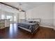 Large main bedroom with wood floors and a decorative beam that provides a modern and rustic touch at 13722 Fox Glove St, Winter Garden, FL 34787
