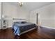 Serene main bedroom with wood floors, a king-size bed, and an en-suite bathroom at 13722 Fox Glove St, Winter Garden, FL 34787