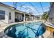Backyard pool surrounded by brick pavers within screened enclosure, perfect for entertaining and relaxation at 13722 Fox Glove St, Winter Garden, FL 34787