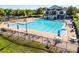 Community pool featuring a lap pool, lounge chairs, umbrellas, and a clubhouse at 13722 Fox Glove St, Winter Garden, FL 34787