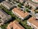 Aerial view of townhomes with meticulously landscaped green spaces and community streets at 14040 Helsby St, Orlando, FL 32832