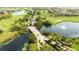 Scenic aerial view of the golf course community with lush greenery, multiple ponds, and beautiful homes at 14040 Helsby St, Orlando, FL 32832
