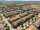 Aerial view of a vibrant community featuring townhomes, lakes, and recreational areas at 14040 Helsby St, Orlando, FL 32832