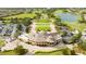 Bird's-eye view of the community clubhouse showcasing its architecture, well-maintained grounds, and golf cart parking at 14040 Helsby St, Orlando, FL 32832