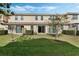 Well-maintained backyard features a lush lawn, privacy hedges and covered patio at 14040 Helsby St, Orlando, FL 32832