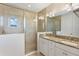Primary bathroom featuring double sinks, granite countertops and a glass-enclosed shower at 14040 Helsby St, Orlando, FL 32832