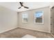 Bedroom with carpet flooring, a ceiling fan and two windows letting in natural light at 14040 Helsby St, Orlando, FL 32832