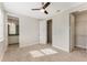 Bedroom featuring carpet flooring, ceiling fan, and ensuite bathroom and walk in closet at 14040 Helsby St, Orlando, FL 32832