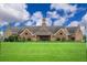 Stunning view of the grand clubhouse, featuring a sprawling green lawn, and elegant architectural details at 14040 Helsby St, Orlando, FL 32832