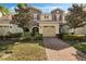 Inviting townhome with a well-manicured lawn and red brick driveway leading to a one-car garage at 14040 Helsby St, Orlando, FL 32832