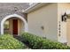 Close up of the front door, with address numbers, landscape and a stone facade at 14040 Helsby St, Orlando, FL 32832