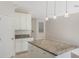 Kitchen with a granite island, ample cabinet space, and stainless steel appliances at 14040 Helsby St, Orlando, FL 32832